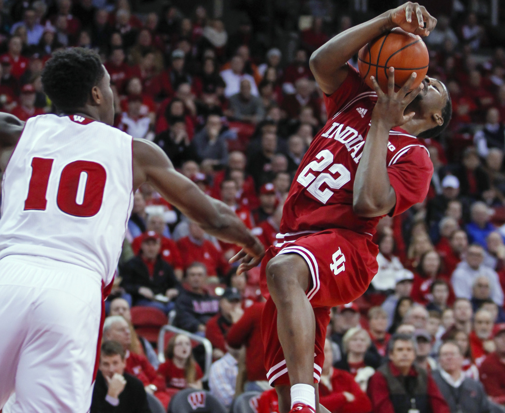 Indiana’s Stanford Robinson, right, tries to get a shot off against Wisconsin’s Nigel Hayes during the first half on Tuesday night in Madison, Wis. The host Badgers won 92-78.