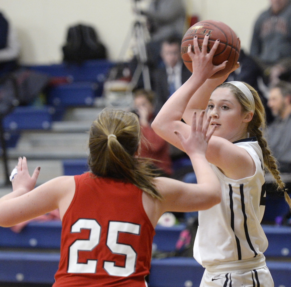 Alison Clark of Yarmouth looks for an open teammate Tuesday night while defended by Skye Conley of Gray-New Gloucester during Gray-New Gloucester’s 43-27 victory at Yarmouth High.