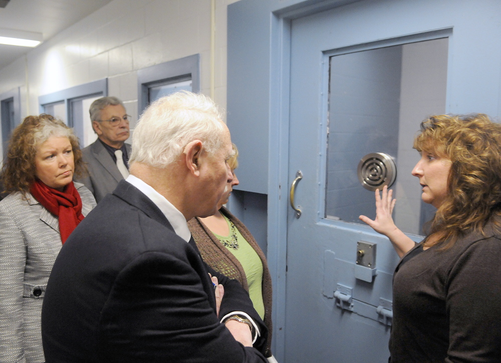 Kennebec County Corrections Capt. Marsha J. Alexander, right, shows members of the Legislature’s Criminal Justice and Public Safety Committee the exterior of a cell that holds high-risk inmates, during a tour of the jail in Augusta on Wednesday.