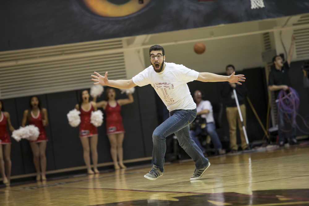 Dan Ray celebrates after sinking a half-court shot worth $10,000 in a promotion at a Temple basketball game. “It was a rush of adrenaline I’ve never felt before,” Ray said.