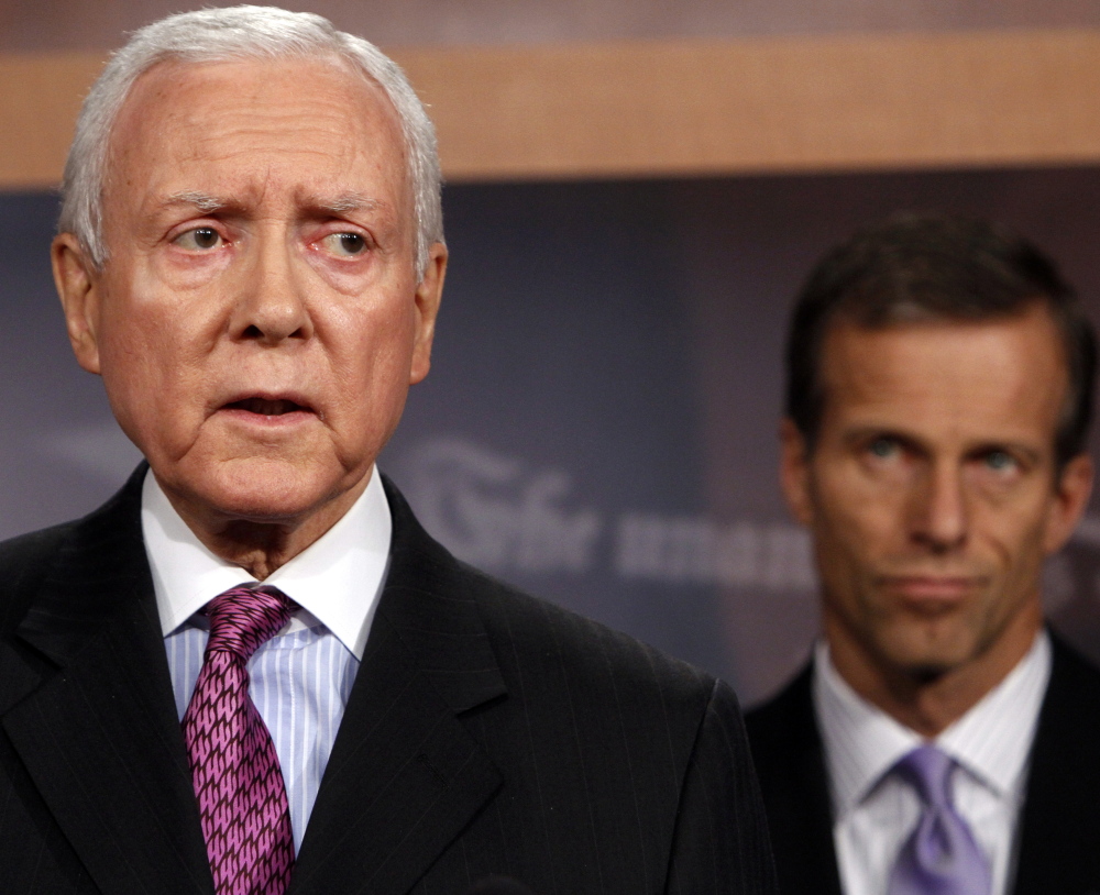 Sen. Orrin Hatch, left, wants to jettison the Health Care Act’s coverage requirement. He and two others will unveil a proposed plan Thursday.