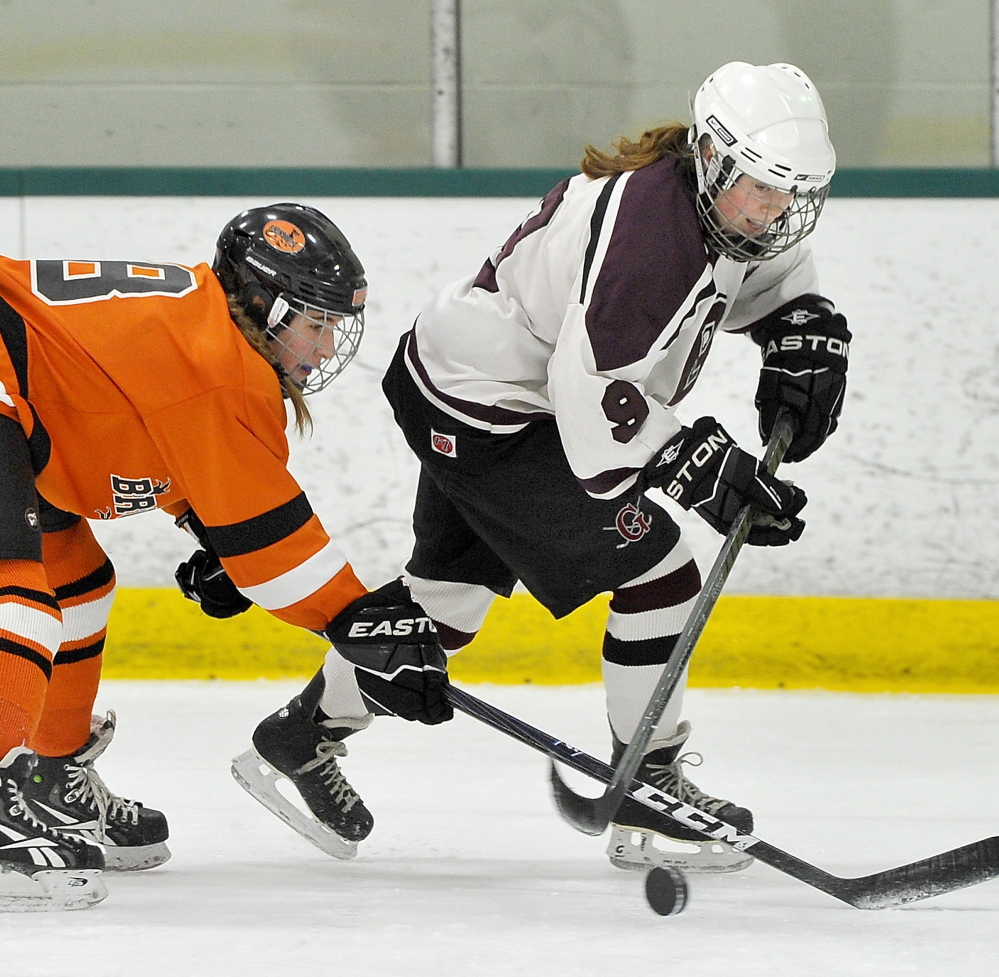 Anna Webster, left, disrupts the fast break by Greely’s Maura Perry during Wednesday’s playoff game at Family Ice in Falmouth.