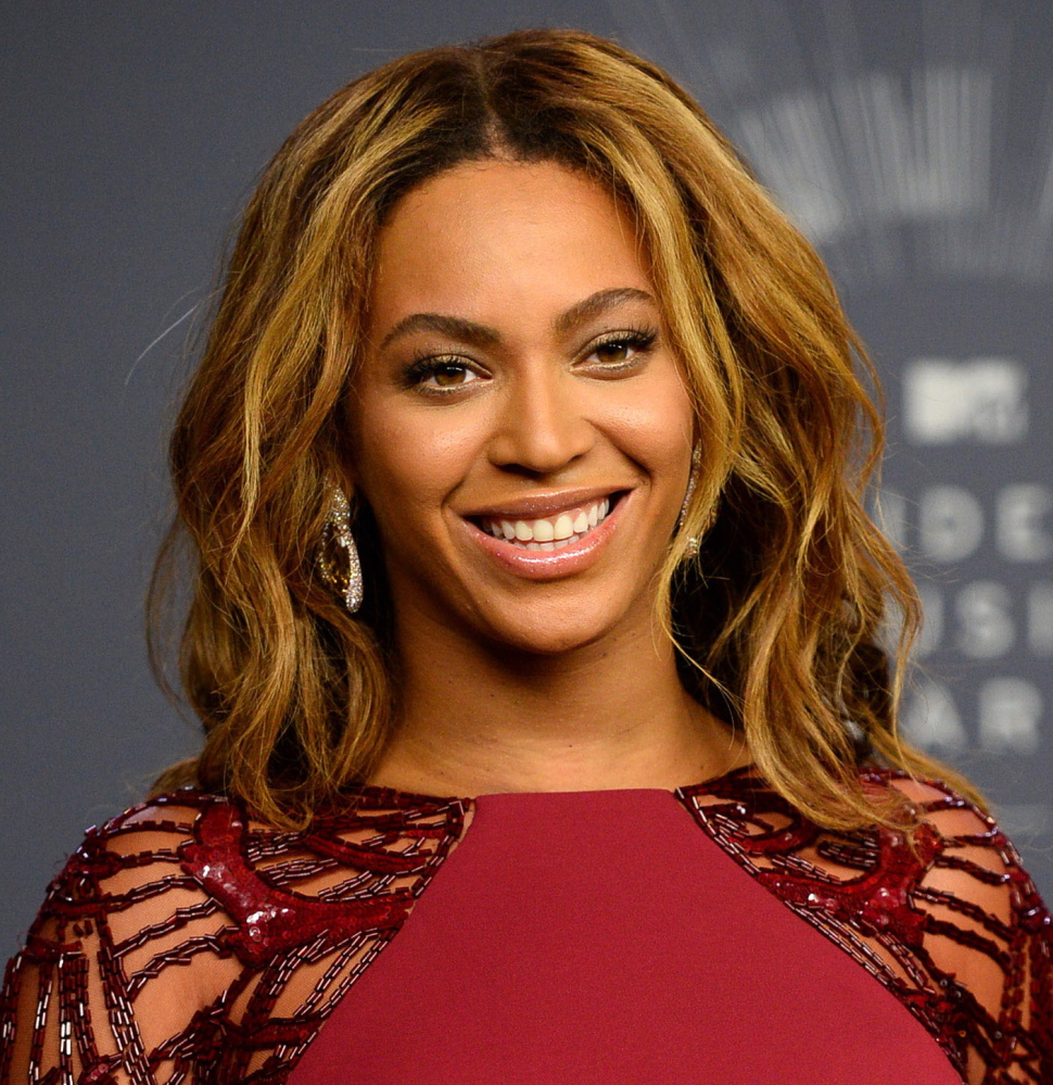 Beyoncé is up for Grammys for album, record and song of the year. Associated Press