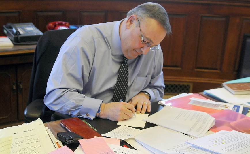 Gov. Paul LePage makes a note while drafting his State of the State speech. Exporting the tax burden, giving low-income workers a break and targeting property tax relief are the right principles.