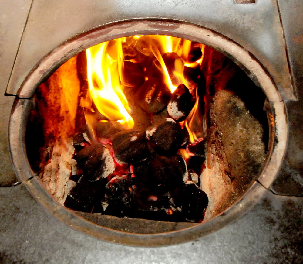 Nut coal begins to catch inside a coal burning stove a the home of John and Ruth Keister in Norridgewock. The Keisters say they enjoy burning coal that is economical, efficient and puts out a lot of heat.