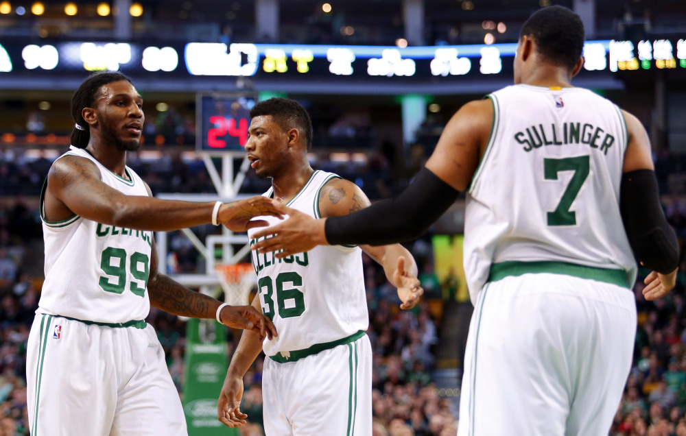 Boston’s Jared Sullinger, right, is congratulated by Jae Crowder (99) and Marcus Smart after making a basket during the second half of the Celtics’ 107-96 win over the Philadelphia 76ers Friday night in Boston. Sullinger finished with a team-high 22 points.