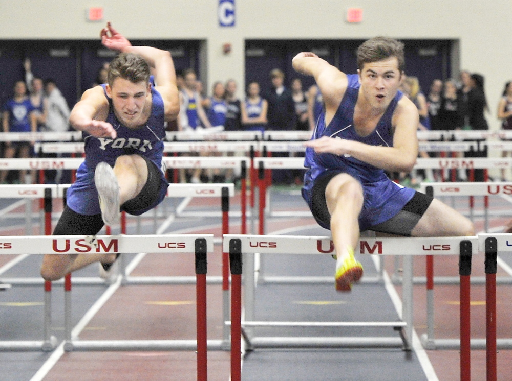 York’s Colt Santoro, right, edges teammate Matt Arsenault to win the 55-meter hurdles at the Western Maine Conference indoor track and field championships in Gorham on Friday. Santoro finished in 8.31 seconds.