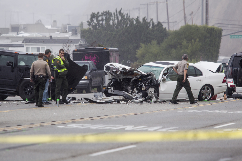 Los Angeles County Sheriff’s deputies investigate the scene of a collision involving three vehicles in Malibu, Calif., on Saturday.