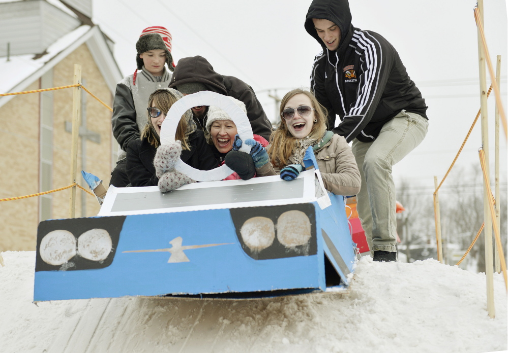 Biddeford’s WinterFest featured a cardboard sled derby with runs on a man-made hill in the middle of downtown. That kid-again thrill of the downhill run registers on the faces of Tina Guay, left, Celeste Guay, center, and Kristy Holden of Biddeford as they get a push from the top of the Adams Street hill.