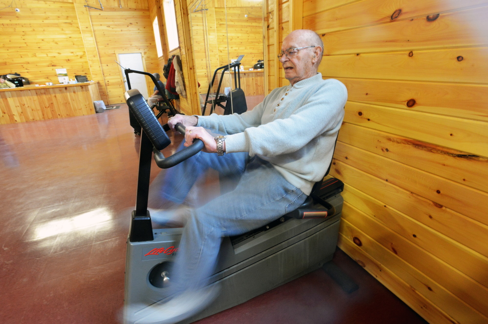 Mike Morris, 87, of Bingham, works out on the stationary bike at the New England Field Service Health Club on Owens Street in Bingham on Thursday. The health club, which opened in a renovated mill in January, is the town’s first.