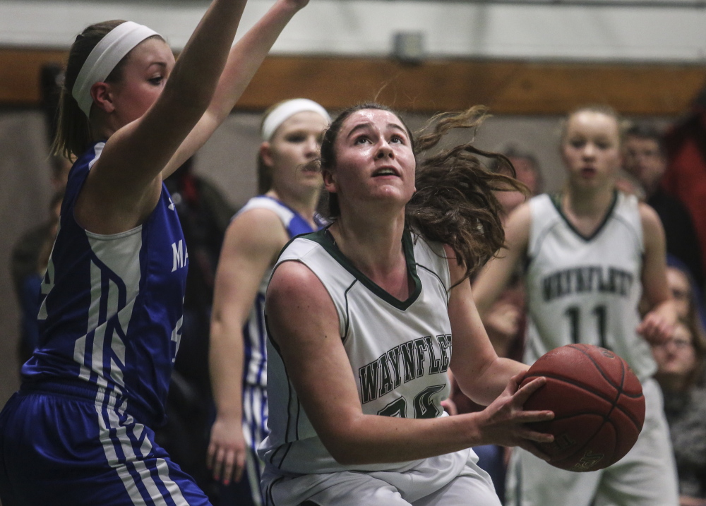 Ali Pope of Waynflete looks to shoot while defended by Erin Whalen of Madison, which will meet Boothbay Region in the quarterfinals at Augusta.