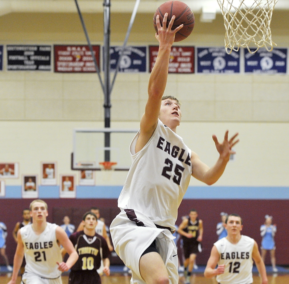Windham’s Jackson Giampino steals the ball and goes in for a layup in Tuesday night’s Western Class A boys’ basketball prelim at Windham. The Eagles won 43-38 and will play No. 1 Portland in the quarterfinals Friday night.