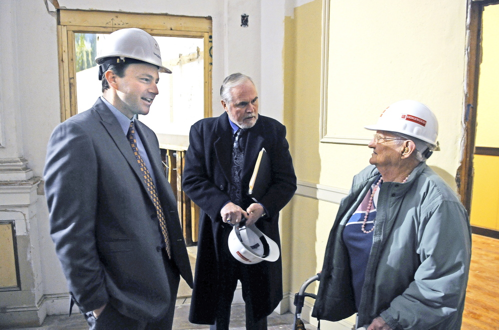 Dorothy Mead, 91, talks Wednesday with Speaker of the House Mark Eves, D-North Berwick, left, and state Sen. David Burns, R-Whiting, at the flatiron building that once served as Cony High School in Augusta. The building is being renovated into senior housing.
