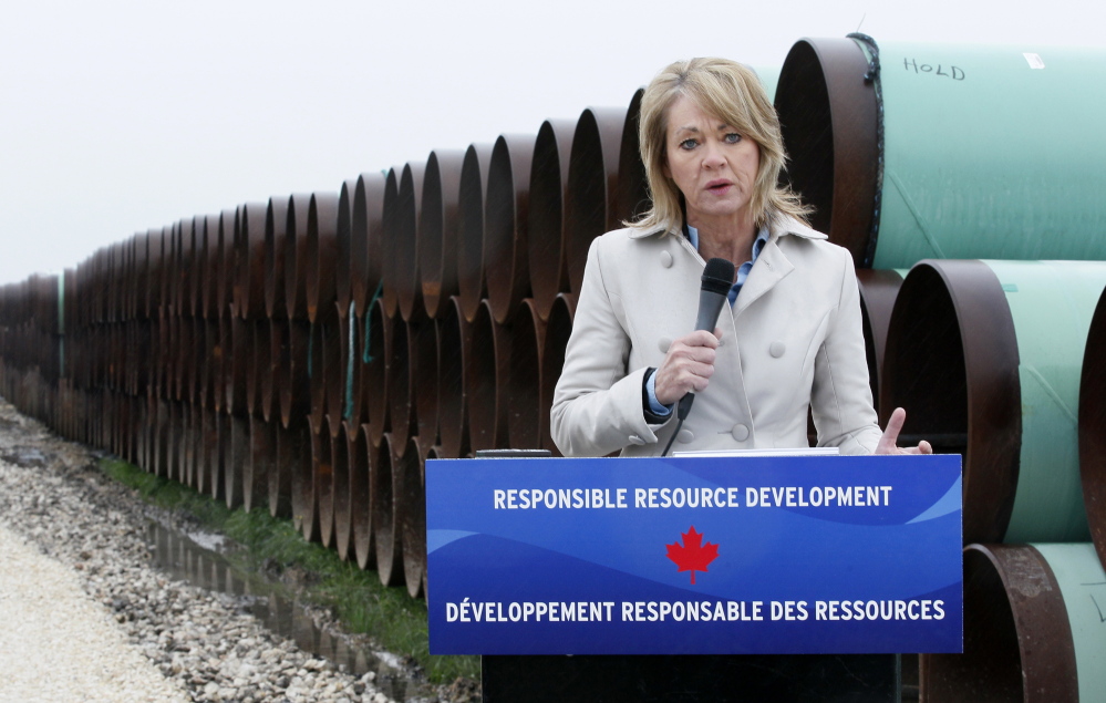 Diana McQueen, Alberta, Canada energy minister, speaks at the pipe yard for the Houston Lateral Project, a component of the Keystone pipeline system in Houston, Texas March 5, 2014.  REUTERS/Rick Wilking (UNITED STATES - Tags: BUSINESS ENERGY) - RTR3G2RG