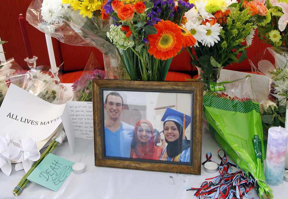 A makeshift memorial at the University of North Carolina-Chapel Hill pays tribute to victims Deah Shaddy Barakat, 23, Yusor Mohammad, 21, and Razan Mohammad Abu-Salha, 19.