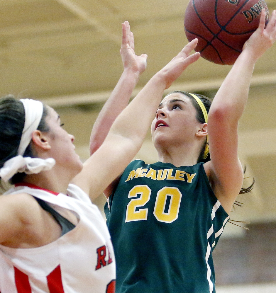 McAuley’s Olivia Dalphonse gets off a shot over South Portland’s Lydia Henderson during their game on Jan. 9. The Lions have won 17 games in a row and are four-time defending state champs, but will face stiff tourney competition.