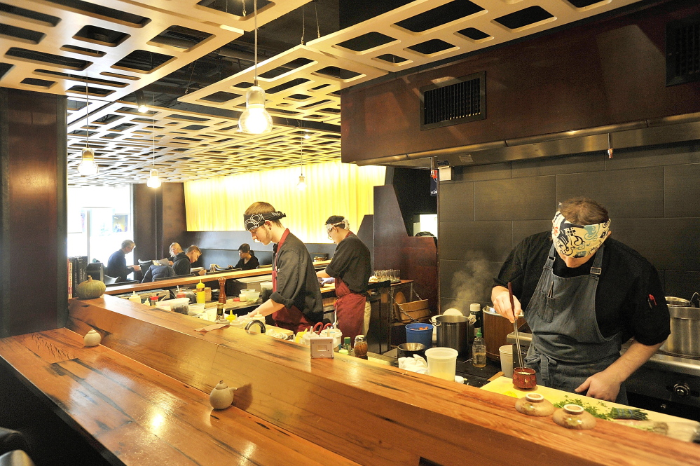 Miyake’s team of chefs at work in the restaurant’s open cooking area.