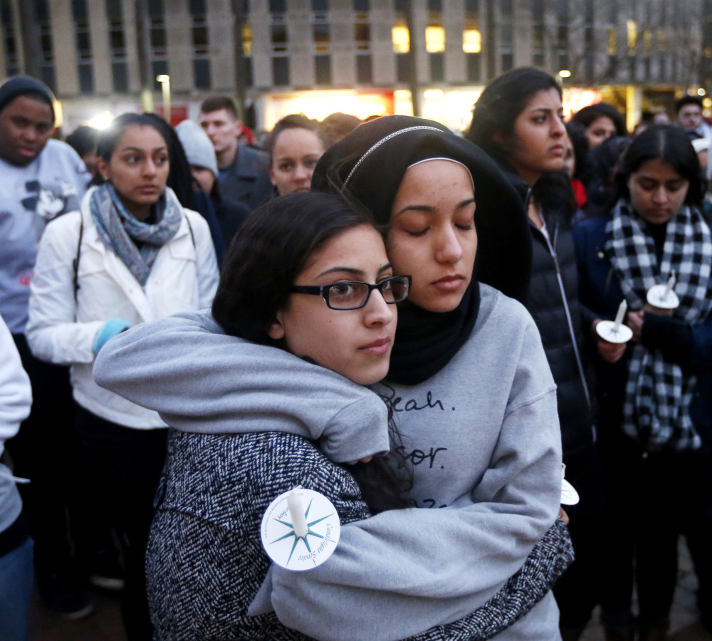 North Carolina State sophomore Firdaws Chahrour, right, hugs Danyah Dahbour before a vigil Thursday on the campus for three Muslim college students killed Tuesday.