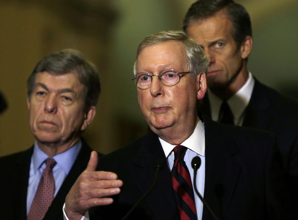 Senate Minority Leader Mitch McConnell, R-Ky., flanked by Sens. Roy Blount, R-Miss., left, and John Thune, R-S.D., faces a possible shutdown.