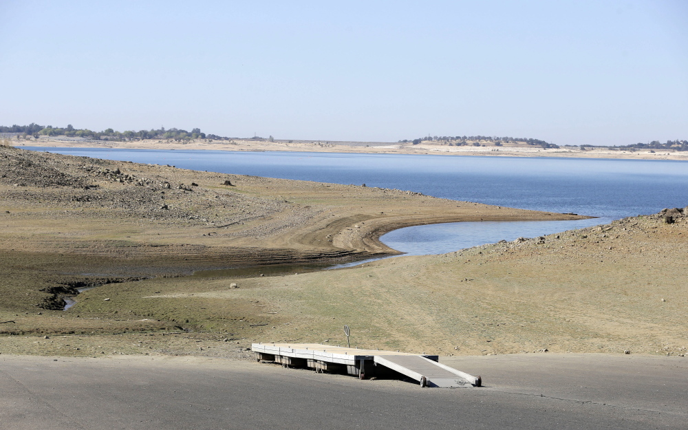 A dock sits high and dry at the end of a boat ramp yards away from the edge of Folsom Lake near Folsom, Calif., in October. Recent storms have eased California’s decade-long drought somewhat, but state officials are worried that the rain will give people an excuse to abandon their already paltry conservation efforts.