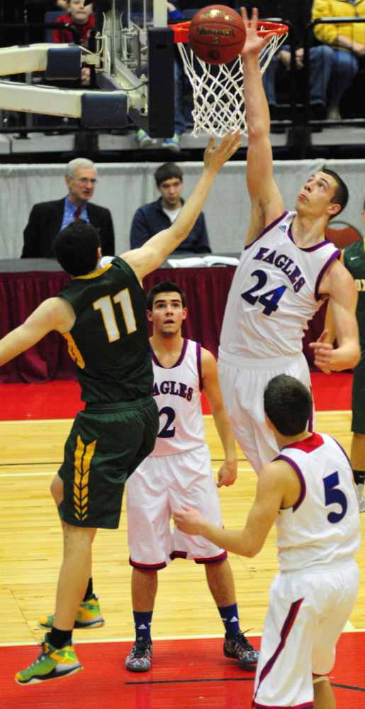 Messalonskee’s Nick Mayo blocks a shot against Oxford Hills forward Tyus Ripley on Saturday at the Augusta Civic Center. Mayo finished with 31 points and 14 rebounds for the Eagles.