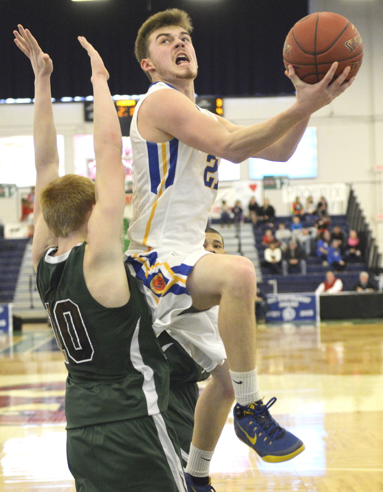 Quinn Piland of Lake Region heads to the basket Saturday while defended by Caulin Parker of Spruce Mountain during Lake Region’s 41-37 victory in a Western Class B boys’ basketball quarterfinal at the Portland Expo.