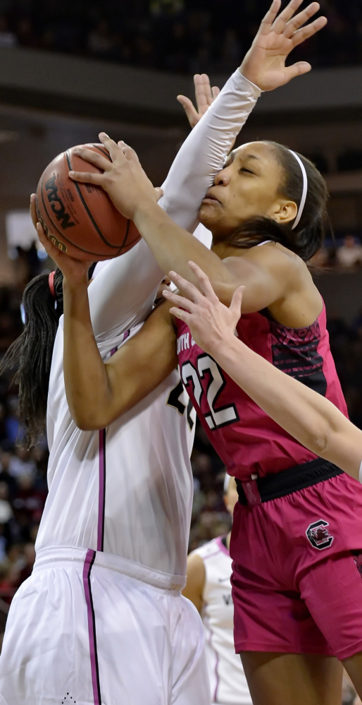 South Carolina’s A’ja Wilson, center, drives to the basket while being fouled by Vanderbilt’s Marqu’es Webb during the Gamecocks’ 89-59 win Sunday.