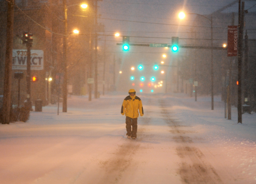 Ron Davis walks to a doctor’s appointment early Monday in Bowling Green, Kentucky. Bitterly cold temperatures are expected to follow the snow, with lows below zero.