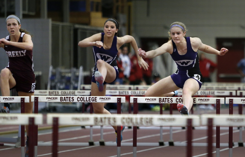FEB. 16:
CLASS B GIRLS INDOOR TRACK
Sarah Shoulta, right, of Waterville races ahead of teammate Kellie Bolduc, center, and Jocelyn Mitiguy of Greely in the 55-yard hurdles final. Shoulta won in 8.79 seconds, and also captured the pole vault at 9 feet, 6 inches to help the Purple Panthers win their fifth consecutive team championship.