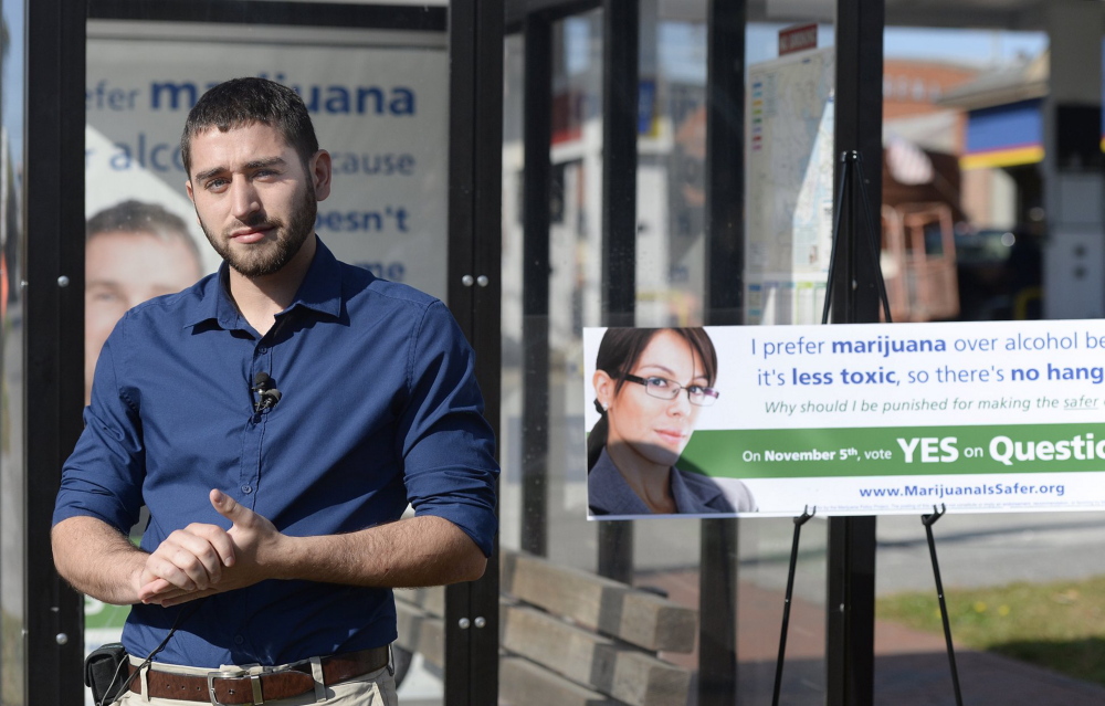 Shawn Patrick Ouellette/Staff Photographer 
 David Boyer of the Marijuana Policy Project speaks with the press near a bus shelter on Park St. in Portland that displays one of the Ads in support of an initiative to remove penalties for marijuana possession  Wednesday, Oct.  02, 2013.