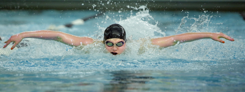 Brunswick sophomore Caitlin Tycz heads toward a victory in the 100-yard butterfly Tuesday at the Class A girls’ swimming and diving championships at Bowdoin College. Tycz also helped the Dragons win both freestyle relays on the way to their first state championship since 2001.