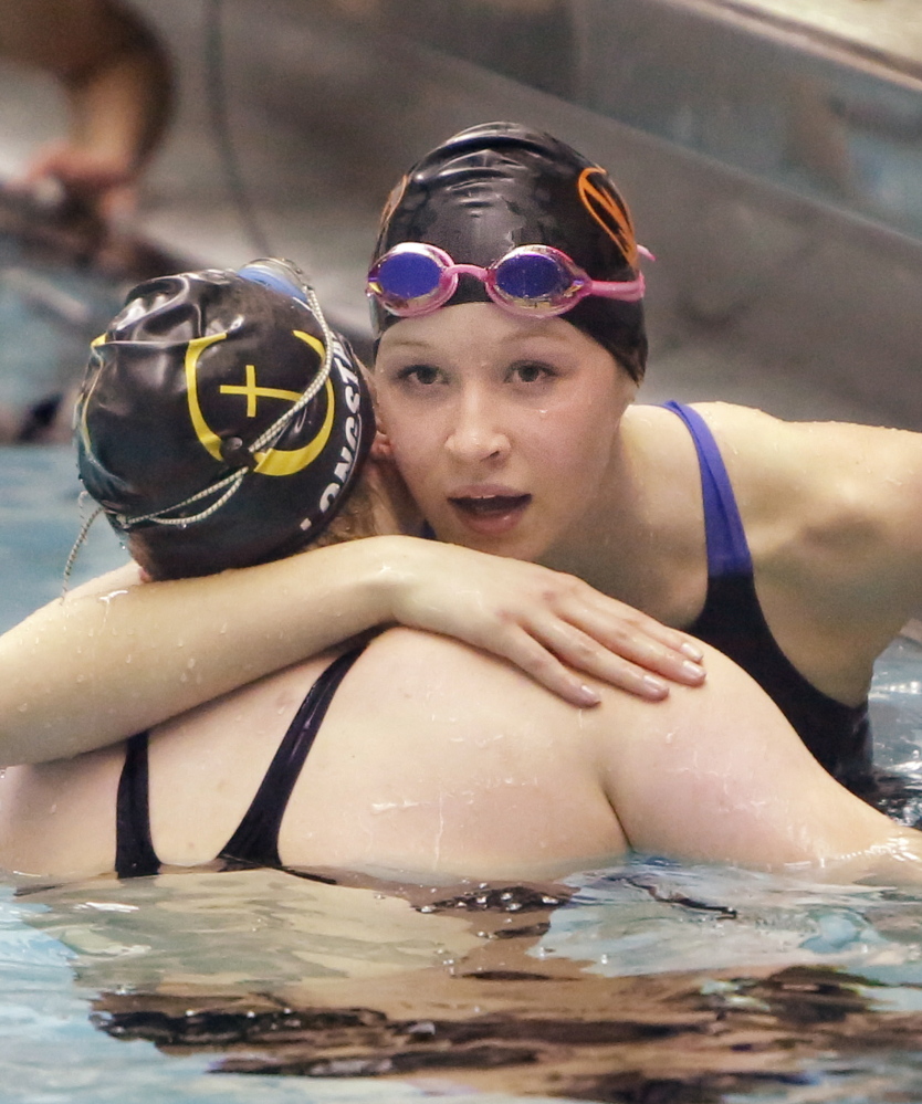 Mariah Brady, a Biddeford senior, wanted to go out with a bang and did just that as performer of the meet. She hugs Abby Longstaff of Cheverus after winning the 100 freestyle.