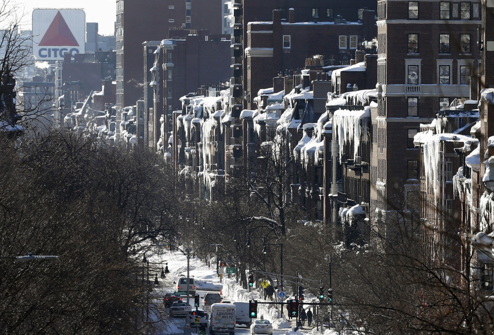 Icicles hang from buildings on Beacon Street in Boston on Monday. For Boston commuters, the situation goes from bad to infuriating as trains are delayed or canceled after an unprecedented succession of heavy snows.