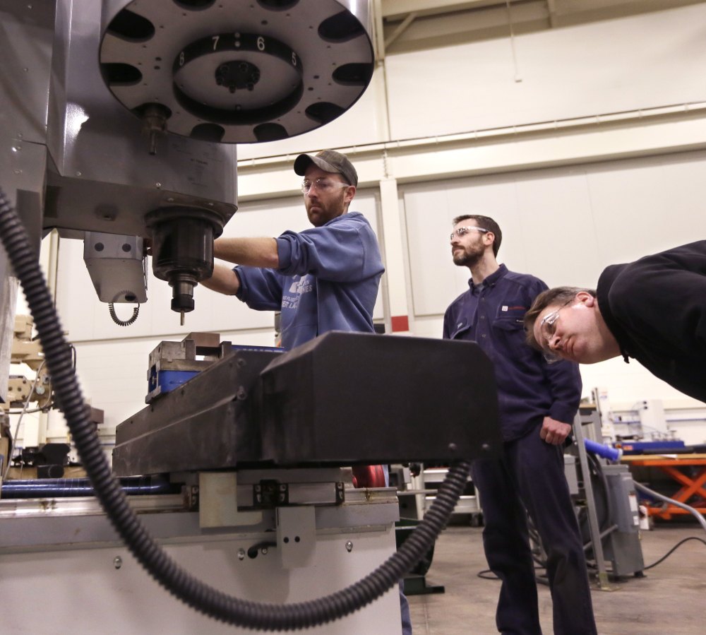 At Lansing Community College, Brad Bancroft, left, operates a mill as others watch during a precision machining class. Gov. Rick Snyder wants to re-establish vocational and technical schooling as an “honorable, equally important” career track.