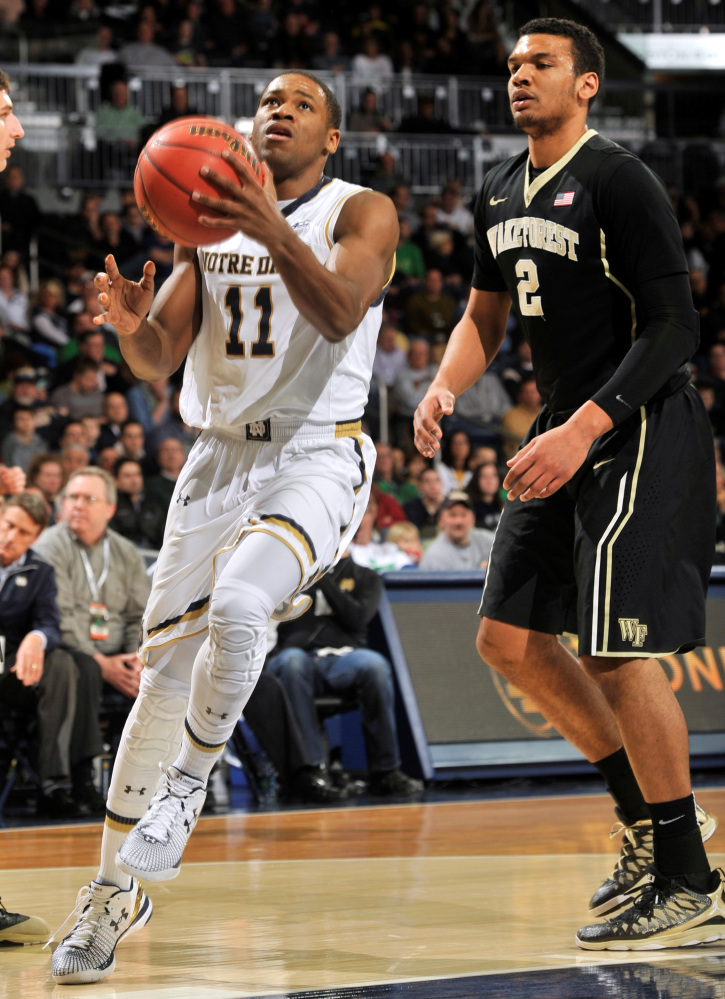 Notre Dame guard Demetrius Jackson (11) drives the lane as Wake Forest forward Devin Thomas (2) defends in the first half of an NCAA college basketball game Tuesday, Feb. 17, 2015, in South Bend, Ind. (AP Photo/Joe Raymond)