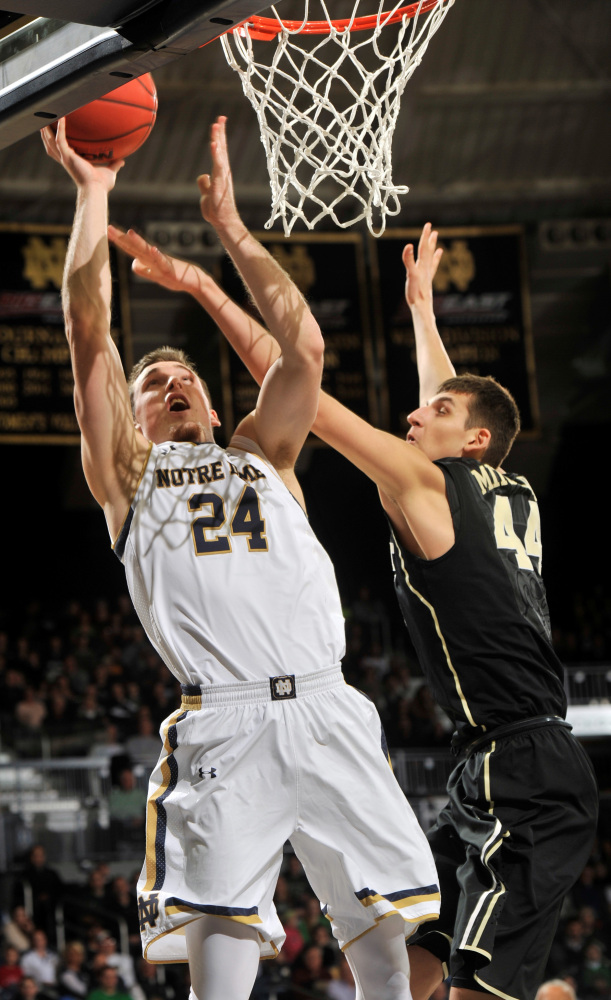 Notre Dame guard Pat Connaughton puts up a shot as Wake Forest forward Konstantious Mitoglou defends on Tuesday night.