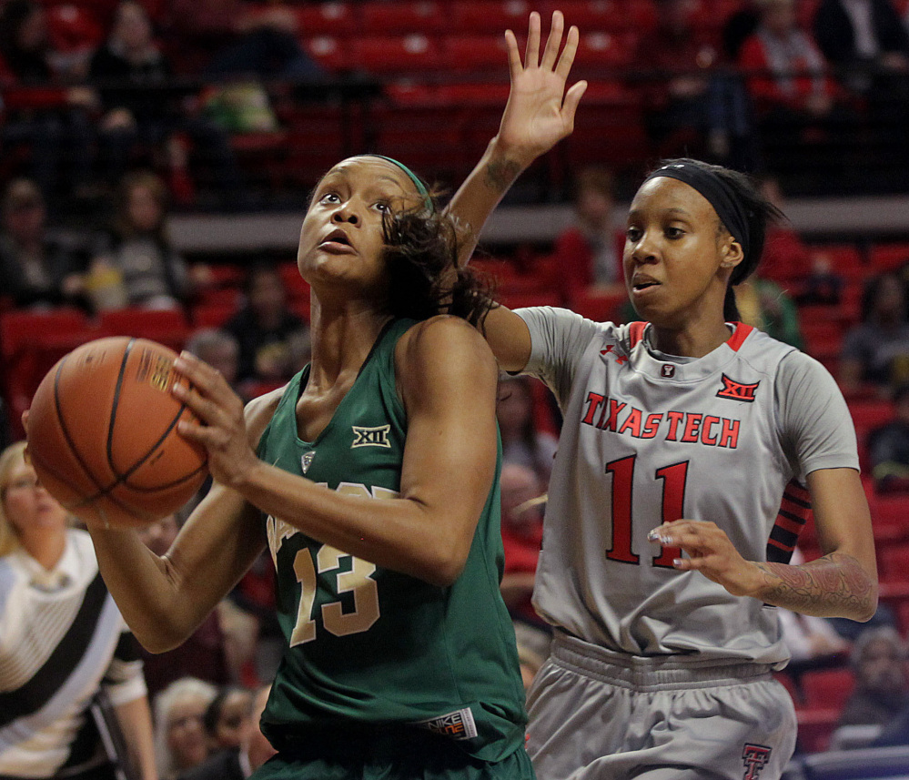 Baylor’s Nina Davis shoots ahead of Texas Tech’s Rayven Brooks in Wednesday’s game at Lubbock, Texas. Davis had 12 points as Baylor won its 24th straight, 67-60.