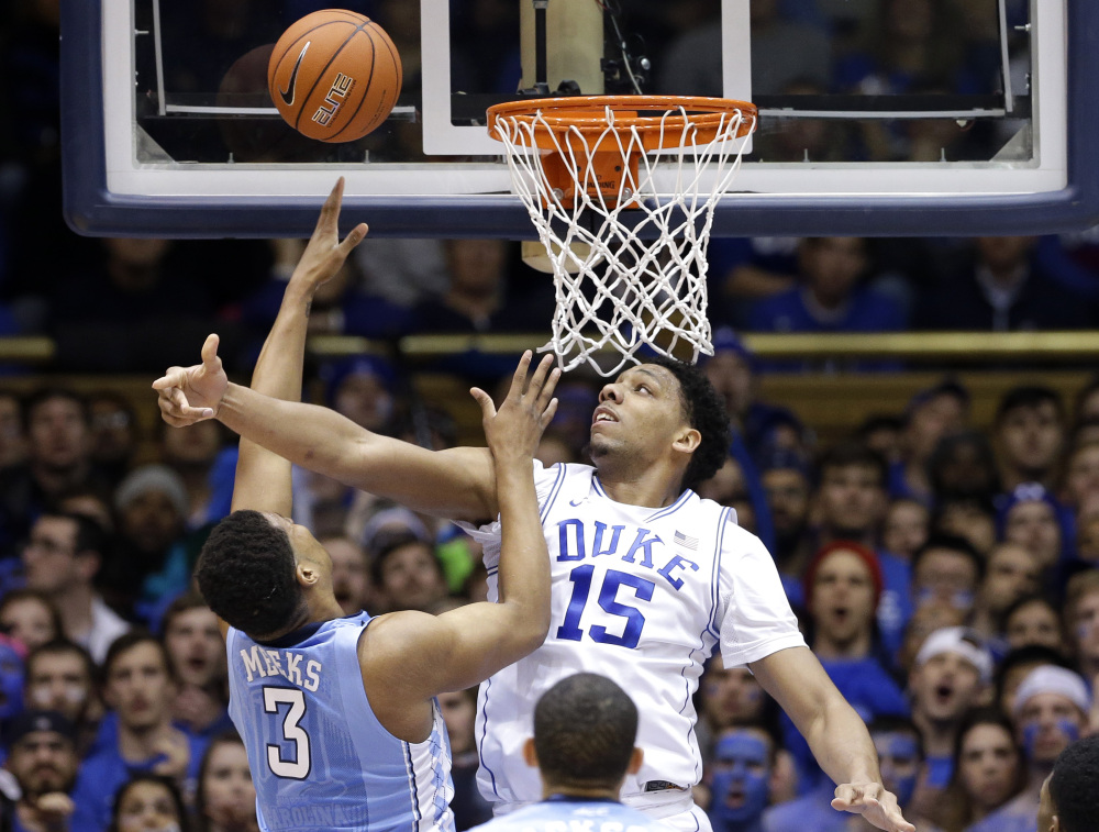 Duke’s Jahlil Okafor defends North Carolina’s Kennedy Meeks in the first half of Wednesday night’s game at Durham, N.C. Duke rallied to beat North Carolina in overtime, 92-90.