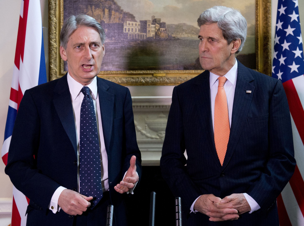 U.S. Secretary of State John Kerry, right, and Britain’s Foreign Secretary Philip Hammond attend a new conference Saturday in London.