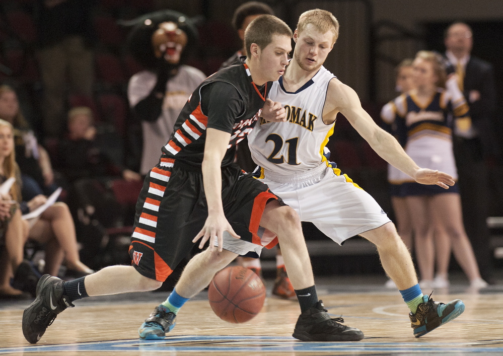 Winslow’s Josh Kervin is closely guarded by Zach Starr of Medomak Valley during the Eastern Class B boys’ basketball final Saturday at the Cross Insurance Center in Bangor. Medomak Valley won, 51-48.