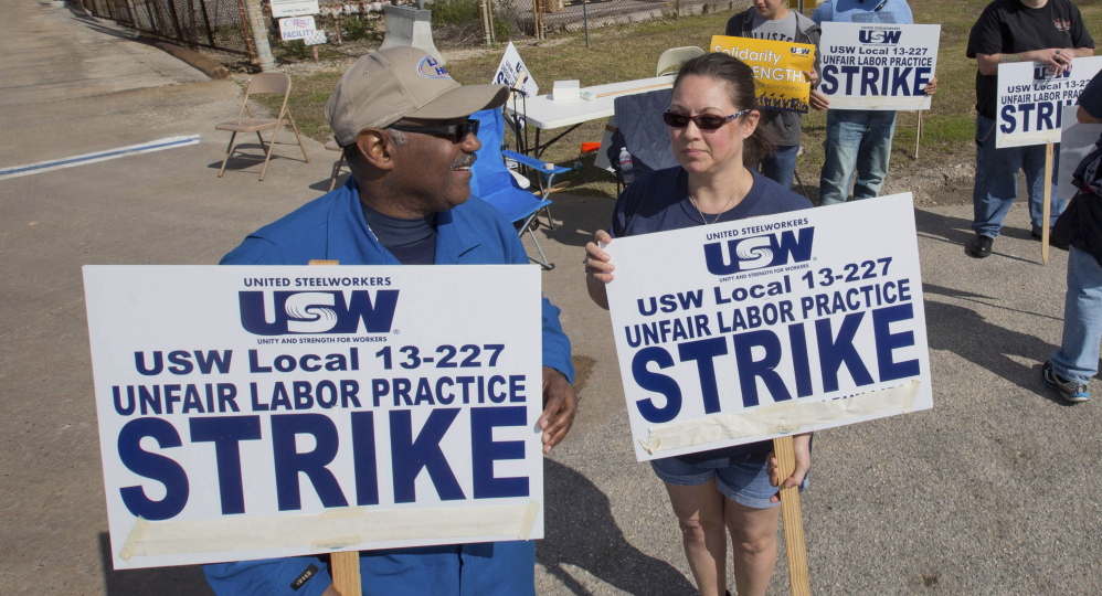 Workers from the United Steelworkers picket outside the Lyondell-Basell refinery in Houston.