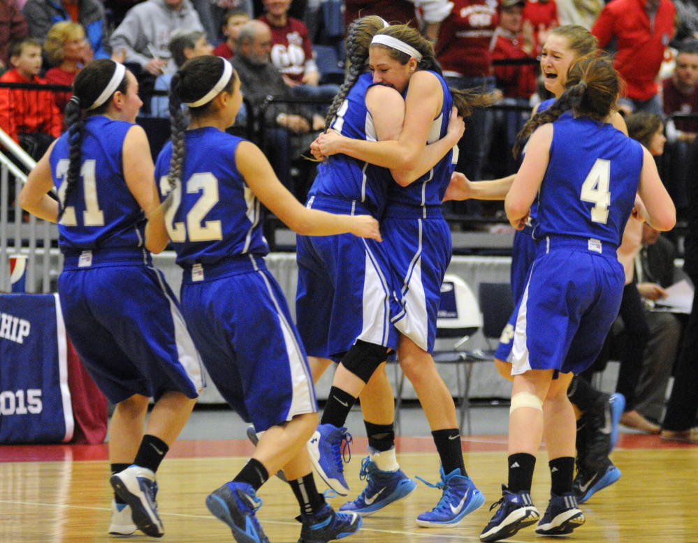 Lawrence players celebrate after a 46-42 win over Bangor in the Eastern Class A girls’ basketball championship game Saturday at the Augusta Civic Center.
