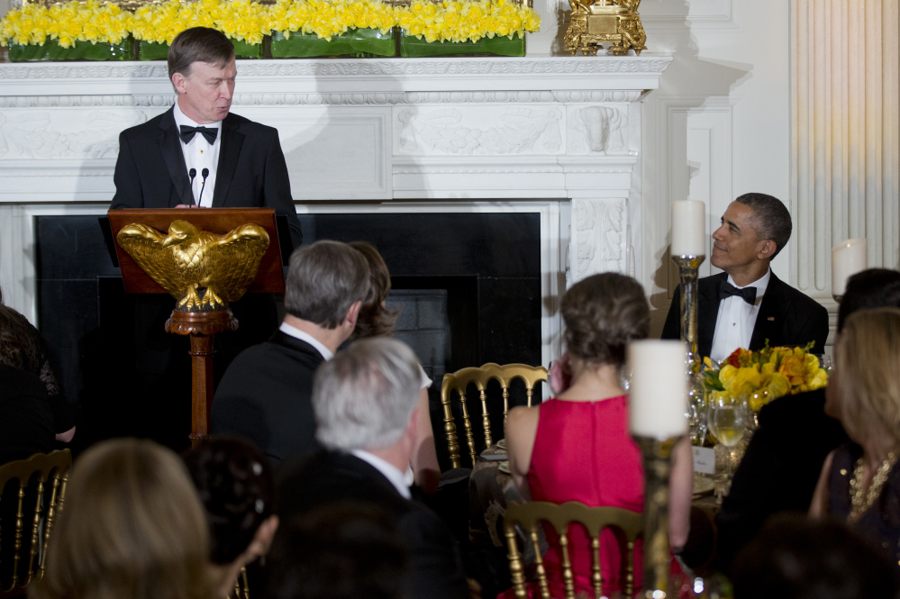 National Governors Association Chairman, Colorado Gov. John Hickenlooper, left, glances at President Barack Obama, right, as he speaks during the National Governors Association, 2015 Governors’ Dinner reception in the State Dining Room at the White House in Washington, Sunday.
