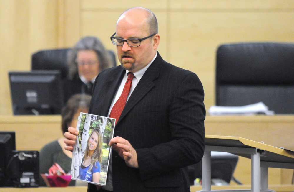 Assistant Attorney General Donald Macomber holds up a picture of Nichole Cable during opening arguments on the first day of Kyle Dube’s trial at the Penobscot Judicial Center in Bangor on Monday.
