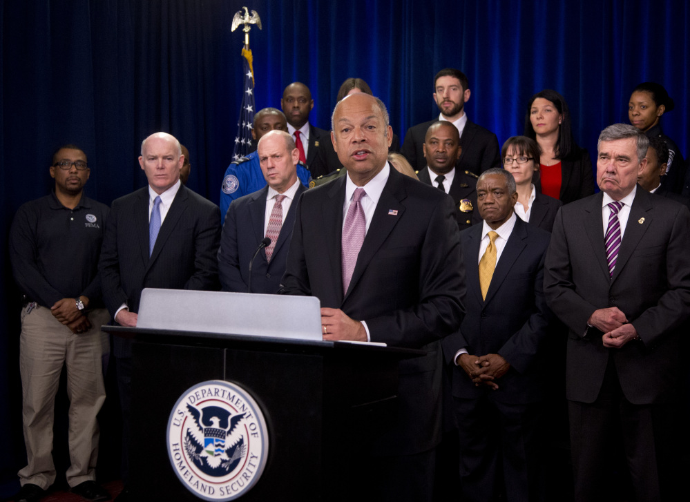 Homeland Security Secretary Jeh Johnson, joined by the department employees, speaks during a news conference in Washington on Monday to discuss the need for Congress to pass a full-year appropriations bill. 