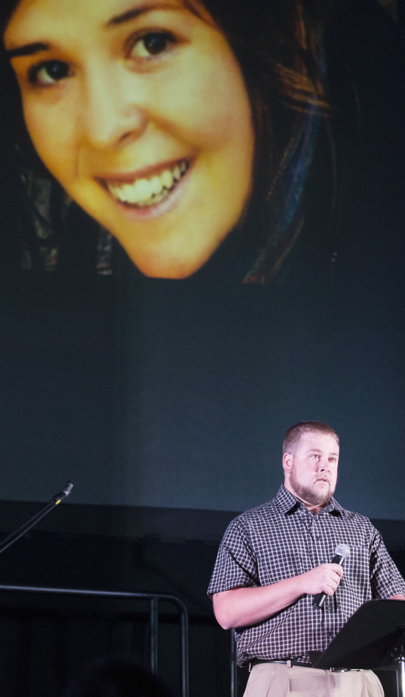 Eric Mueller talks about his sister, Kayla Mueller, during a candlelight memorial in Prescott, Ariz., last week. Mueller’s family says the government valued policy more than their family.