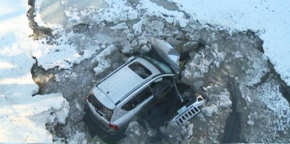 The three people in this SUV when it went airborne Monday and landed on the frozen Crooked River were able to get out and swim to shore, suffering from hypothermia.