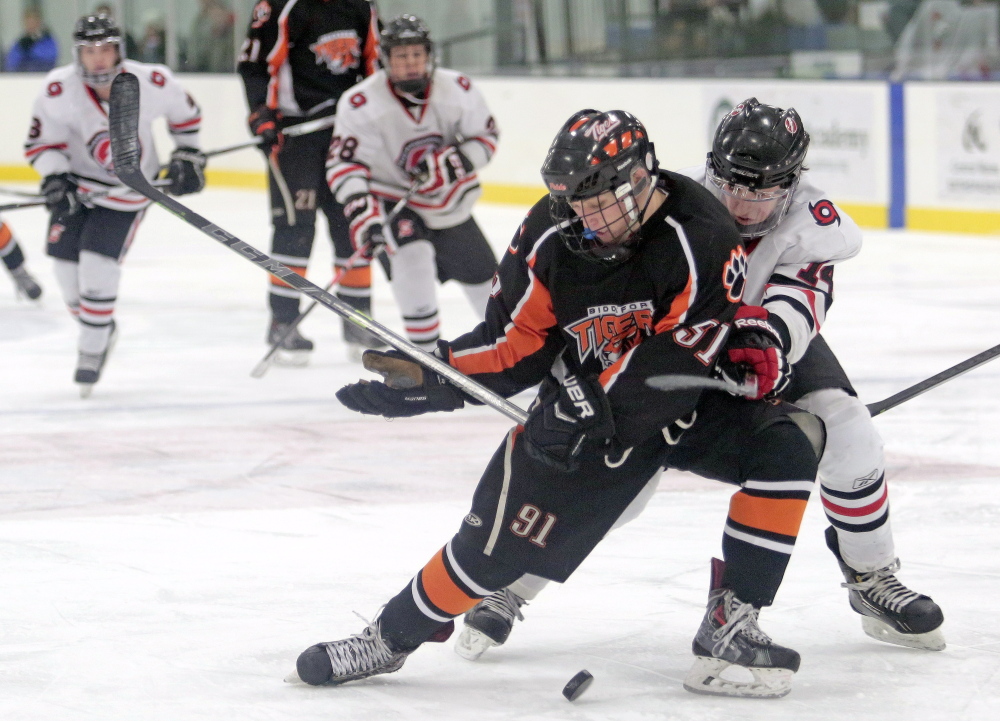 Biddeford's Ricky Ruck tries to fend off Scarborough's Sean McDonald.
Gabe Souza/Staff Photographer