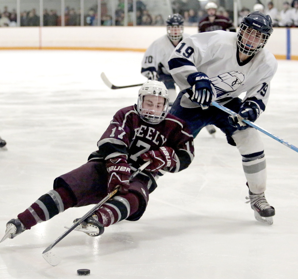 Greely’s Dylan Fried tries to control the puck in front of Yarmouth’s Matt Madrid as he slips and falls to the ice. Greely finished 3-15-1 this season, but was able to hang in with the second-seeded Clippers.