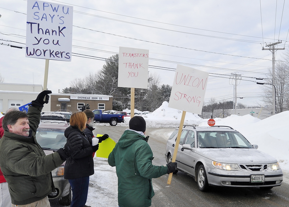 PORTLAND, ME - FEBRUARY 25: Tim Doughty, a postal worker with the American Postal Workers Union, left,  joins State Rep. Mark Bryant, Doug Born, Jen Nappi, and Joe Piccone of the Teamsters, as they thank Fairpoint workers returning to work on Davis Farm Road after a long strike. (Photo by Gordon Chibroski/Staff Photographer)